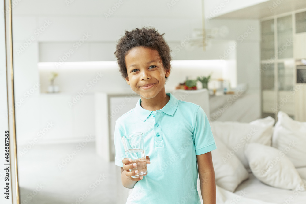 Child drinks water on at home on white background Child drinks water on at home on white background