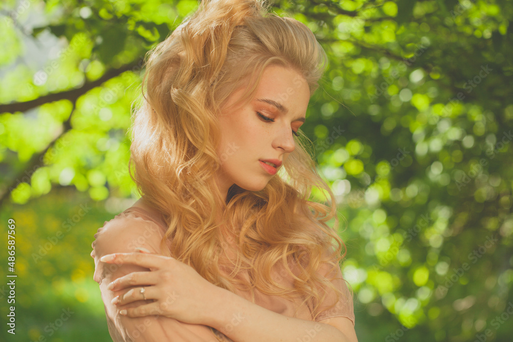 Beautiful dreamy young woman relaxing in the shade of the trees on a warm summer day Beautiful dreamy young woman relaxing in the shade of the trees on a warm summer day