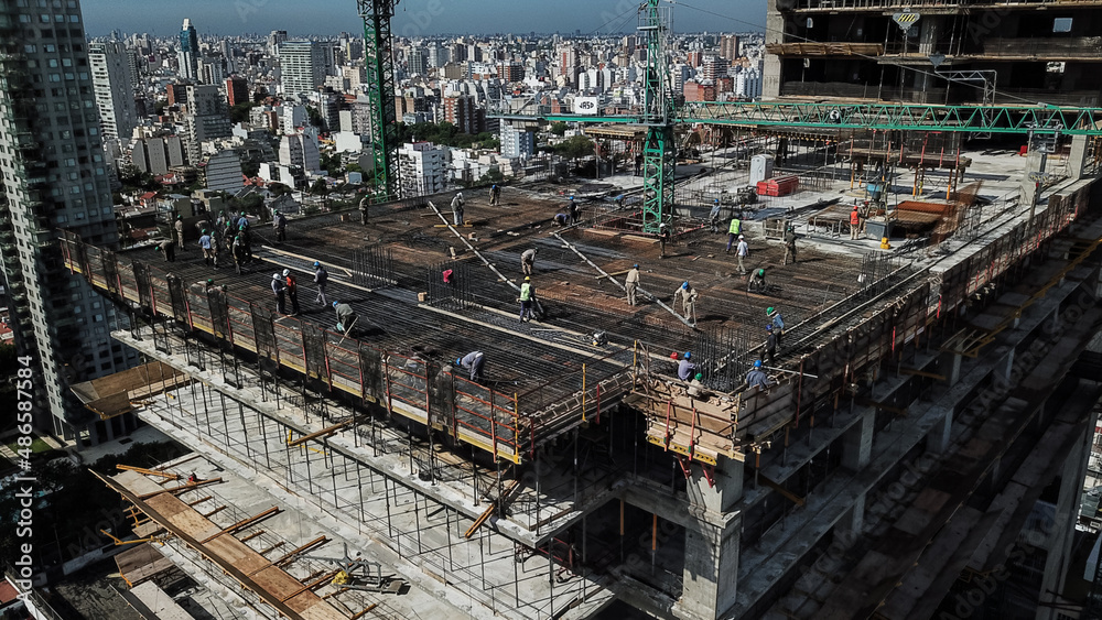 Aerial view of busy industrial construction site workers with cranes working Aerial view of busy industrial construction site workers with cranes working