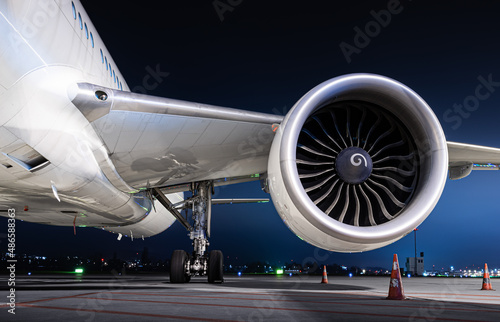 airliner wing equipped with a powerful engine at night 