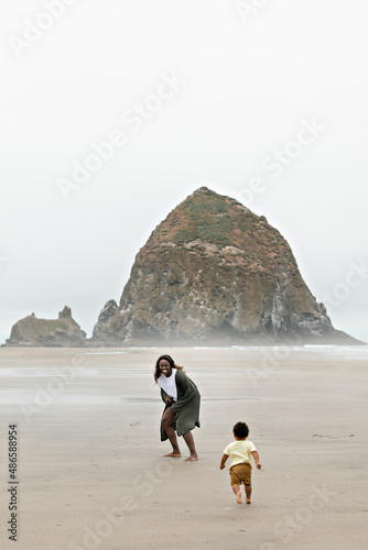 Toddler Chasing Mother on Beach
