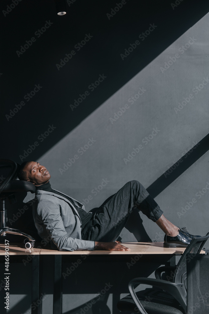 A black man in a gray business suit in the office A black man in a gray business suit in the office