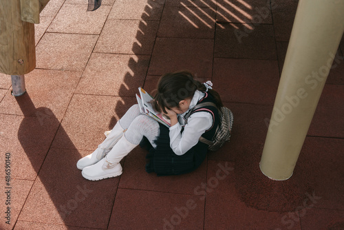 Children abuse the girl. The girl is crying . photo