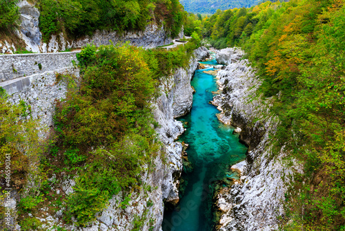 the crystalclear Water of River Soča cutes deep into Limestonerocks, autumn in Kobarid, Slovenia photo