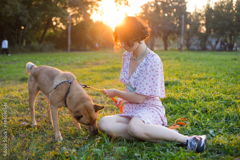 girls with dog sit on the grass Stock Photo | Adobe Stock