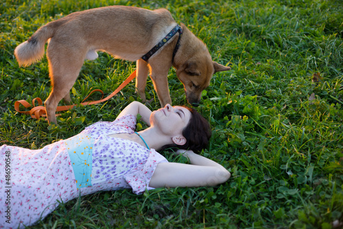 the girl lies in the grass
 photo