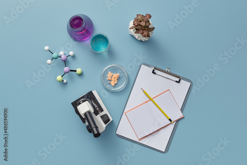Microscope and notebook with pencil