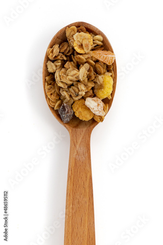 crunchy granola in wooden spoon isolated on white background