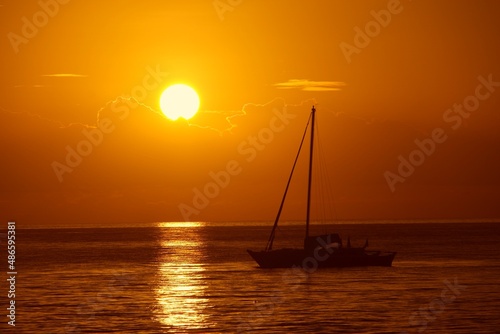 Sailboats and a beautiful red and orange sunset Silhouettes of yachts in the tropical sea ocean boat catamaran sailing zanzibar