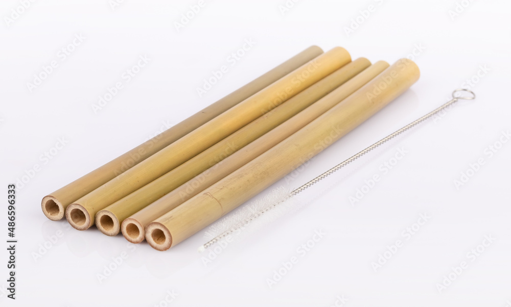 Bamboo straws on a white background. Ecological bamboo straws. Thanks to these bamboo straws, we can be a more environmentally conscious society. Say no to plastic. Bamboo straws on a white background. Ecological bamboo straws. Thanks to these bamboo straws, we can be a more environmentally conscious society. Say no to plastic.