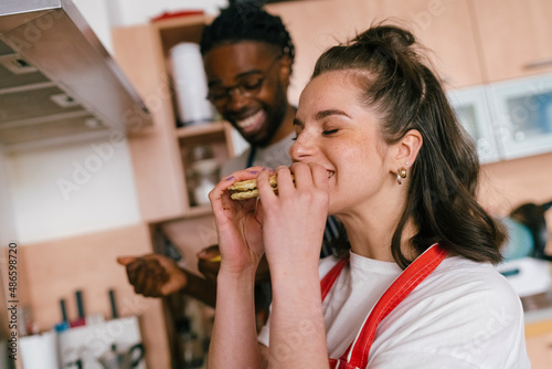 The woman eats homemade cookies.