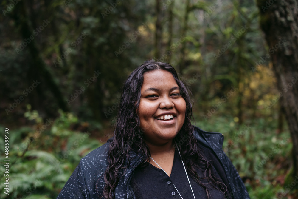 Smiling young woman in raincoat. Smiling young woman in raincoat.