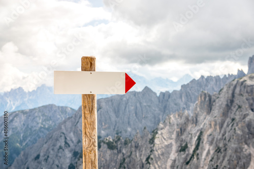 Close up of blank directional sign along a mountaintop path. Copy space.