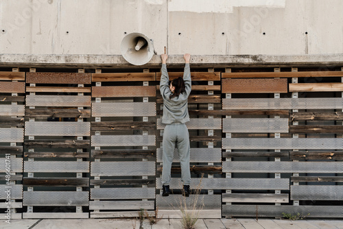 Woman hanging from a wall photo