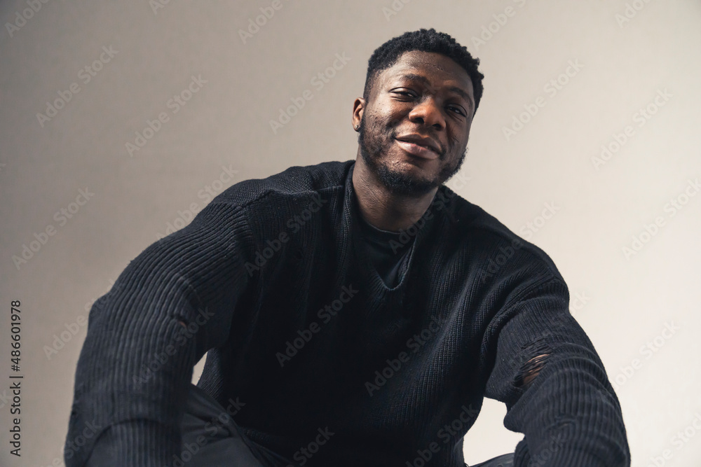 smiling black men sitting looking at the camera white background - portrait shot. High-quality photo smiling black men sitting looking at the camera white background - portrait shot. High-quality photo