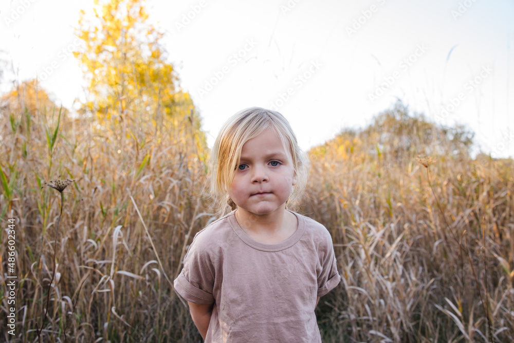 Serious girl in long grasses. Serious girl in long grasses.