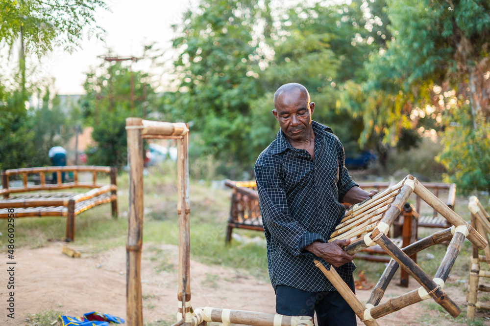 Man with bamboo chair Man with bamboo chair