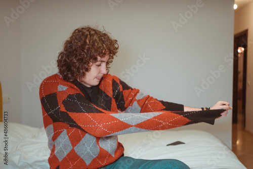 Girl taking off sweater in bedroom  photo