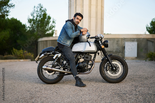 Brutal man on motorcycle in city