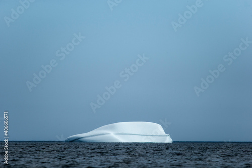 Icebergs floating in the melting sea ice in the Davis Strait. photo