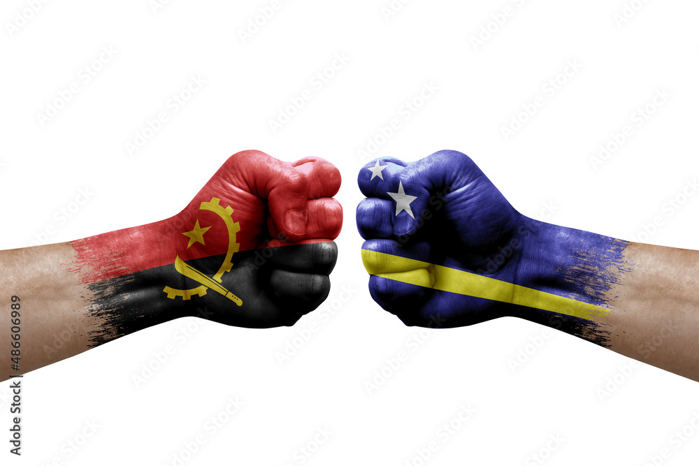 Two hands punch to each others on white background. Country flags painted fists, conflict crisis concept between angola and curacao Two hands punch to each others on white background. Country flags painted fists, conflict crisis concept between angola and curacao