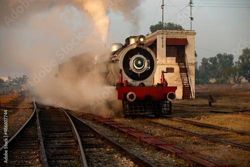 A steam locomotive passing a signal cabin ! photo