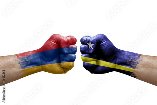 Two hands punch to each others on white background. Country flags painted fists, conflict crisis concept between armenia and curacao