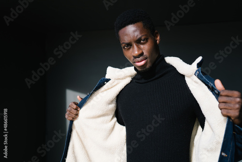 Black guy opening warm jacket photo