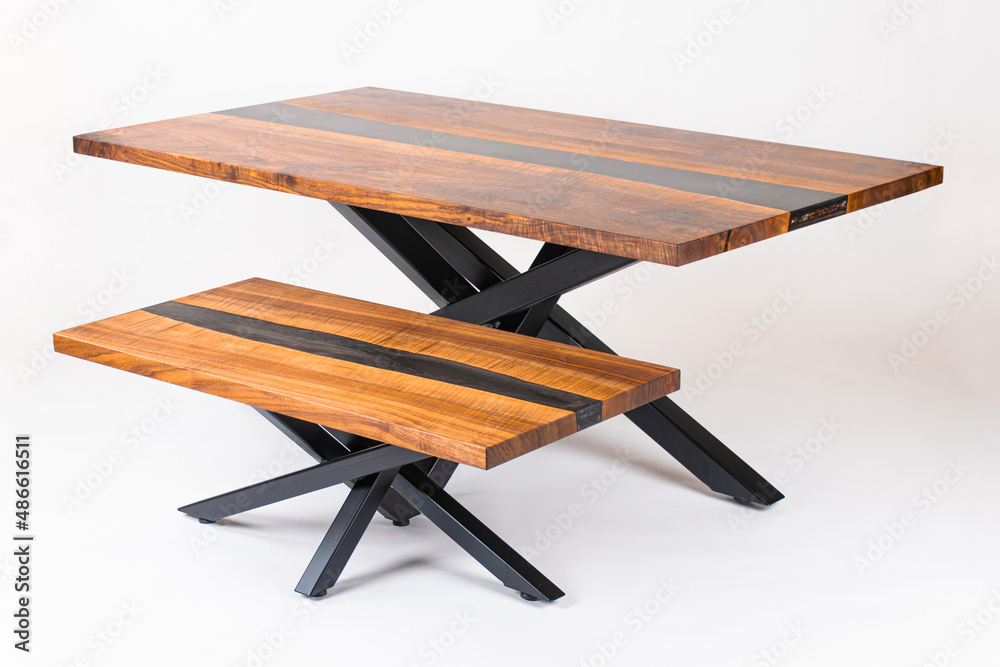Curly Bastogne Walnut wooden table and coffee table with black epoxy resin and metal legs. White studio backdrop. Curly Bastogne Walnut wooden table and coffee table with black epoxy resin and metal legs. White studio backdrop.