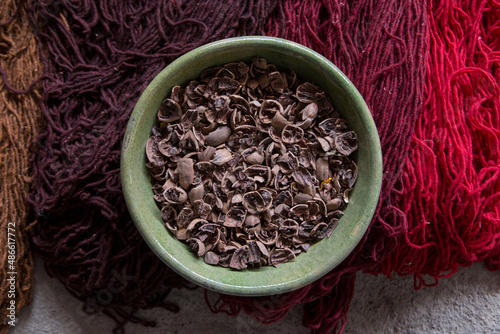 walnut shells on painted threads for Oaxaca rugs photo