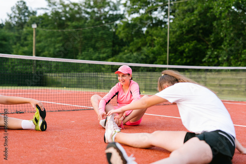 Happy kids stretching after tennis practice outdoor