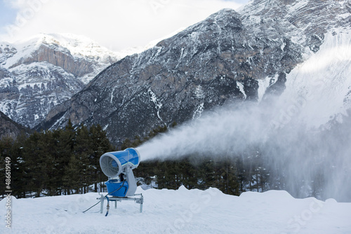 snow gun machine producing artificial snow photo