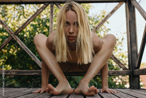 Blonde Woman doing yoga outside in the nude clothes  photo
