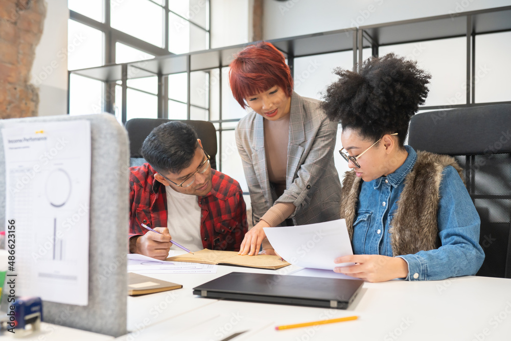 © Hernandez & Sorokina/Stocksy - Teamwork Between Colleagues At Office Desk