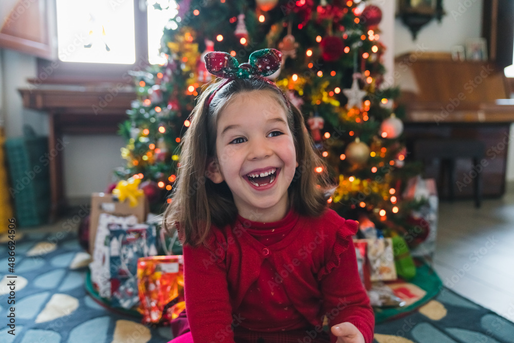 Exuberant Little Girl in front of the Christmas Tree Exuberant Little Girl in front of the Christmas Tree