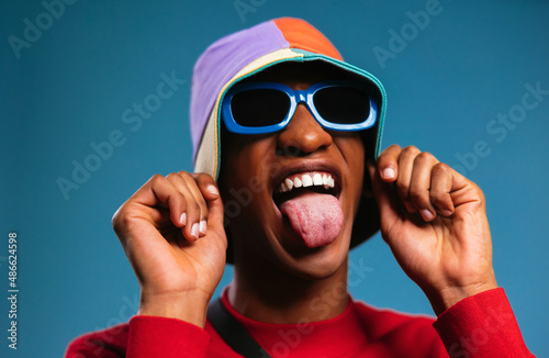 Fashionable black guy showing tongue photo