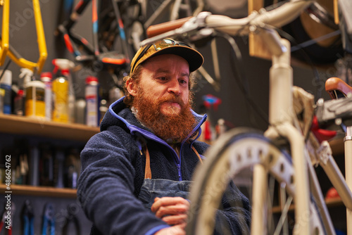 BIke mechanic checking wheel blot