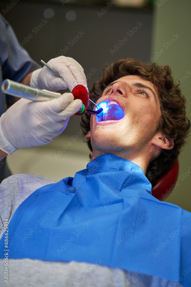 Dentist using ultraviolet light Dentist using ultraviolet light