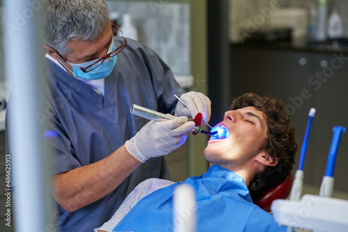 Dentist using ultraviolet light