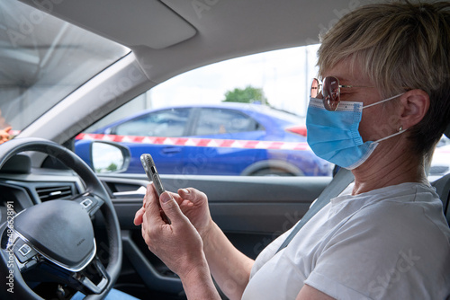 Woman sitting in car at a coivd-19 testing centre photo