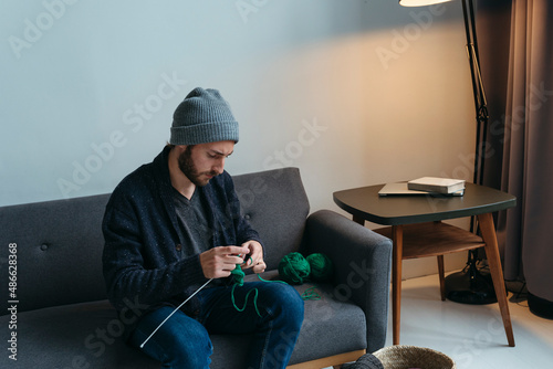 Knitter young adult man. photo