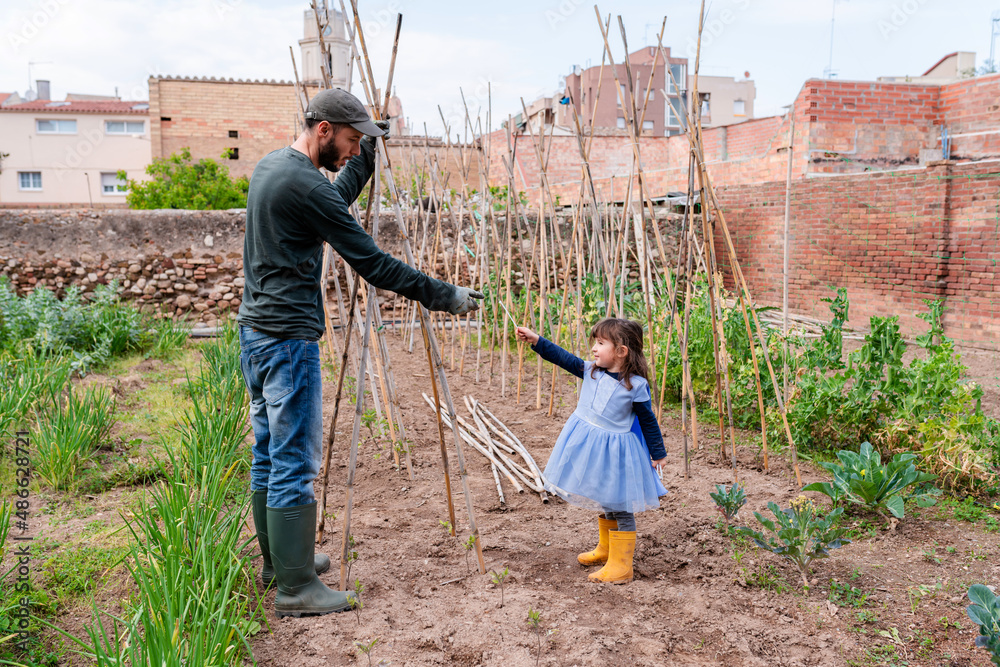 Daughter and father together in the garden Daughter and father together in the garden