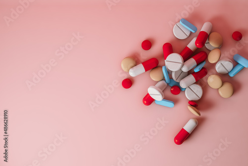 Top view of pills on pink background photo