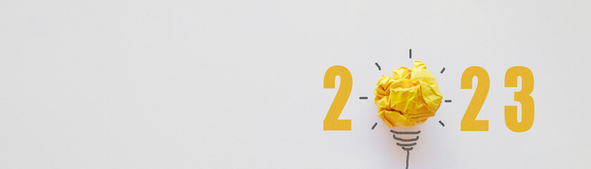2023 Yellow paper light bulb, new year innovative business vision and resolution concept