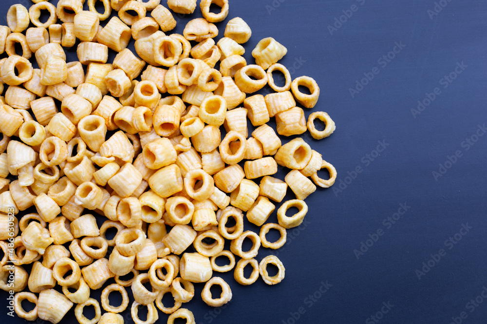 Crispy potato rings on dark background. Crispy potato rings on dark background.