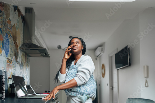 Woman Carrying Baby and Talking on Phone