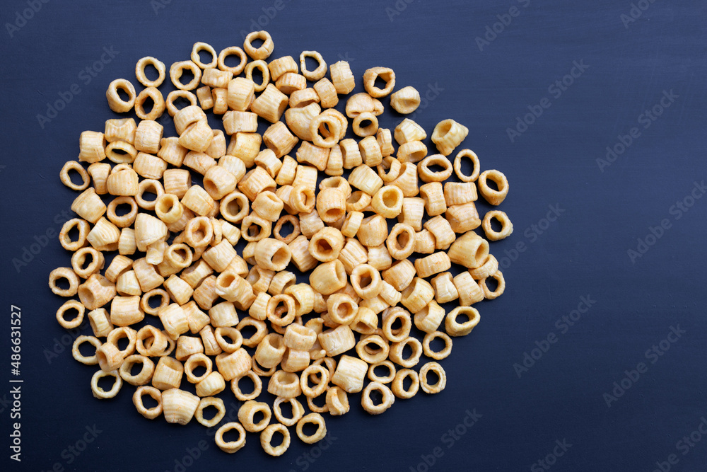Crispy potato rings on dark background.