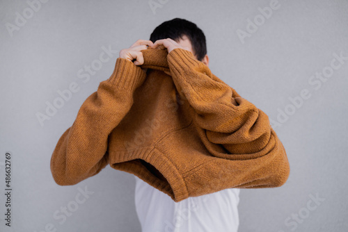 Pulling Sweater Over Head