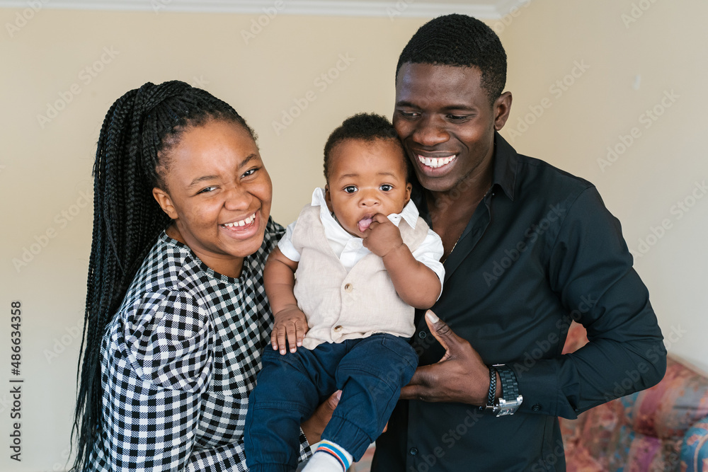 Cheerful mother and father with black toddler Cheerful mother and father with black toddler