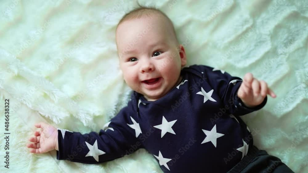 Playful baby laying on the bed. Adorable happy little kid smilling. Playful baby laying on the bed. Adorable happy little kid smilling.